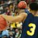 Michigan junior Tim Hardaway Jr. attempts to balance a ball on his neck while goofing around during an open practice at the Georgia Dome in Atlanta on Friday, April 5, 2015. Melanie Maxwell I AnnArbor.com